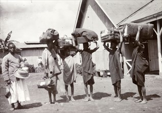 Porters at the station. Frederick Stanbury's safari porters balance large bundles of luggage on