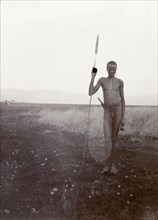 Portrait of a Kenyan man, 1906. Portrait of a naked Kenyan man holding a long spear taken on safari