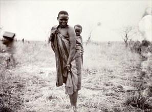 Kenyan woman and child. Portrait of a Kenyan woman, her baby strapped to her back with a length of