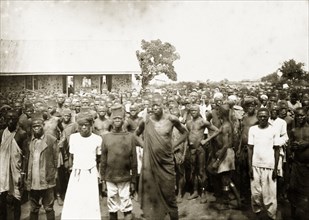 African workers on strike, Kisumu. A large crowd of African men and women stands outside a
