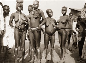 Luo women at Kisumu. Portrait of four nearly naked Luo women at a local market. Kisumu, British