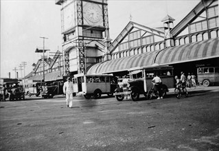 Buses outside the market. Buses parked outside the large clock tower in the central market place.