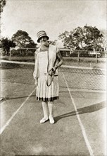 Margaret trotter plays tennis. Portrait of Margaret Trotter in her sporting whites, posing racquet