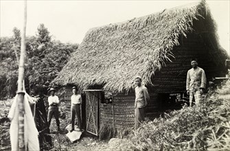 British surveying team at Bukit Asa. British surveyors and their Malay assistants at a thatched