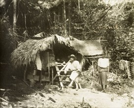 Bintang-Kendrong boundary camp. British surveyor and his Malay assistant at a survey camp on the