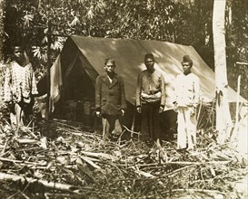 Malay surveying assistants. Malay assistants outside a camp on a British-led trigonometrical survey