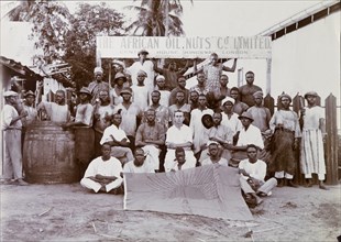 Staff of the African Oil Nuts Company. Group portrait of a European overseer and African staff of