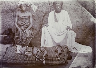 Nigerian couple with newborn babies. Portrait of a Nigerian couple with four naked newborn babies.