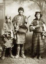 Beggar musicians, India. Studio portrait of three itinerant female musicians, probably of Tibetan