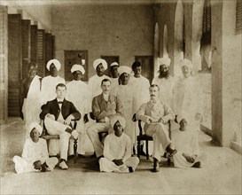 Bank of Bengal 'chummery'. Group portrait of a Bank of Bengal 'chummery' with Indian servants.
