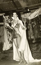 Carnival Queen beauty pageant. A beauty pageant contestant, Wendy Lawrence, poses on stage holding
