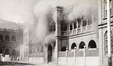 Riot damage in Aden, 1947. Smoke engulfs a building in the Jewish quarter of Aden, during the Arab