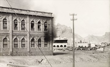Building set on fire during the Arab riots in Aden, 1947. Black smoke billows from a building in