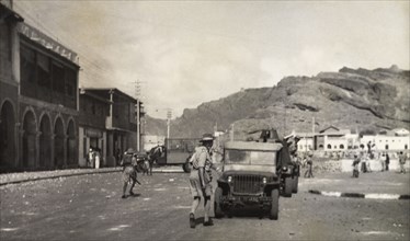 Patrols during the Arab riots in Aden, 1947. Armed police or soldiers patrol the streets of Aden in