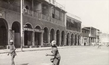 Rioting in Aden, 1947. A man takes aim in throwing an object at a bazaar in Aden, during the Arab