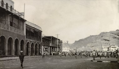 Rioting in Aden, 1947. A large crowd of people roam a wide street in the Jewish quarter of Aden,