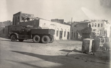 Aftermath of Arab riots in Aden, 1947. An army truck with a trailing tow rope is parked near