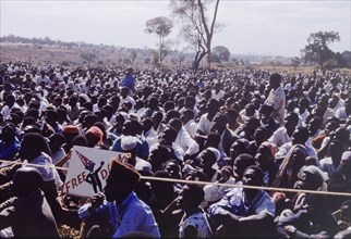 Crowd at United National Independence Party rally. A crowd of Zambian supporters sit and watch a