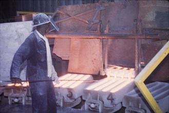 Moulding copper, Nkana-Kitwe. A smith oversees the pouring of refined copper from a furnace into
