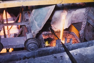 Pouring copper at Nkana-Kitwe mines. Copper is poured into a furnace during the refining process at