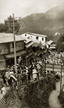 Bazaar at Mussoorie, India. Crowds bustle past a line of ramshackle buildings at a bazaar in