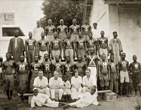 Christmas photograph of staff at the African Oil Nuts Company and Miller Brothers. Three rows of
