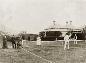 Mixed-doubles tennis match. A mixed-doubles tennis match on a grass court at 'Nundora', the house