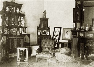 Domestic interior at 'Wyalla'. The corner of a heavily furnished drawing room at 'Wyalla',