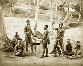 Andaman Islanders. Outdoors portrait of a group of Andaman Islanders. Two men holding staffs and