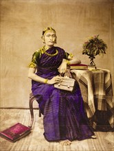Southern Indian woman. Portrait of a southern Indian woman seated on a European-style chair beside