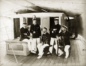 Officers aboard RIMS 'Elphinstone'. Group portrait of five uniformed officers posed on the deck of