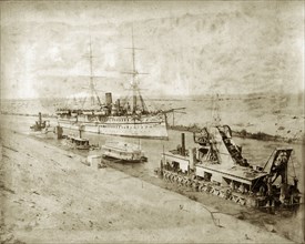 The 'Malabar' in the Suez Canal. HM Indian troopship 'Malabar' in the Suez Canal. A dredger and