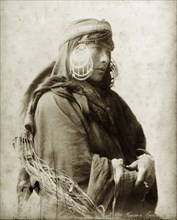 Portrait of a bedouin woman. Portrait of a north African bedouin woman. She wears large, striking