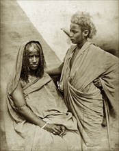 Bischarin women. Portrait of two Bisharin women, their hair worn in traditional style. Sudan, North