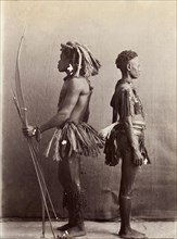 Andaman Islanders. A man and a woman from the Andaman Islands stand, back to back in profile,