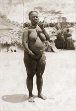 Woman from the Andaman Islands. Portrait of a semi-naked woman from the Andaman Islands smoking a