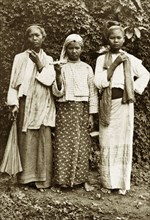 Three Burmese women. Outdoors portrait of three young Burmese women wearing traditional dress.