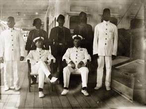 Engine room officials. Group portrait of six uniformed engineer room officials posed on the deck of