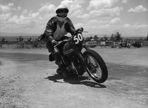 Number 50 in mid-race. Good is captured mid-race as he rides motorcycle number 50 in an event at