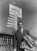 John Bentley at Nairobi airport. Hollywood film star John Bentley poses in front of a signpost