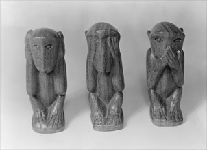 Hear no evil, see no evil, speak no evil. Three wooden ornaments, carved into the shape of monkeys.