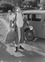 Father Christmas arrives. A man dressed as Father Christmas arrives in costume for a children's