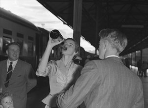 Wendy Winter drinks champagne. Wendy Winter (nee Allen) drinks champagne from the bottle before
