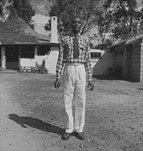 Portrait of 'Robert'. A Kenyan man identified as 'Robert', poses stiffly for the camera dressed in
