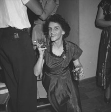 Last night of 'Cinderella'. A woman enjoys herself, drinks in hand, at a party being held for the