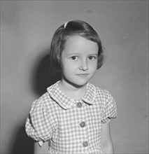 Burt Condon's daughter. A European child identified as 'Burt Condon's girl', poses shyly for the