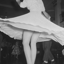 Spinning around. Close up shot of a girl's legs, appearing from beneath her dress which flares