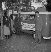 Volkswagen Mobile Service School. A European man introduces three Maasai warriors to a 'Volkswagen