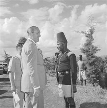 Lennox-Boyd visits Fort Hall. Alan Tindal Lennox-Boyd (1904-1983) stands on a roadside beside a