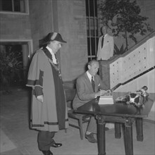 Lennox-Boyd opens City Hall. Alan Tindal Lennox-Boyd (1904-1983) signs the visitors book at the